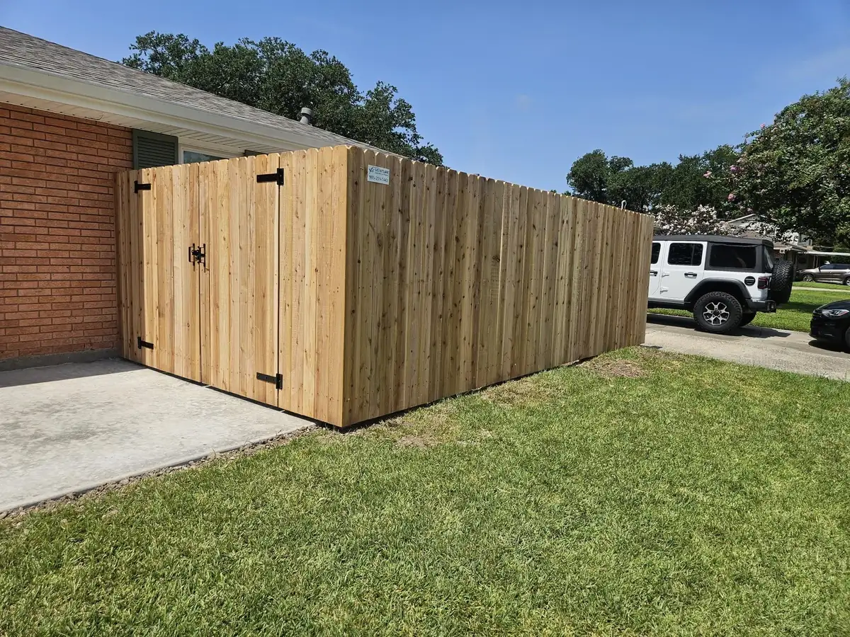 Cedar privacy fence with a double gate installed by Venture Concrete & Fencing