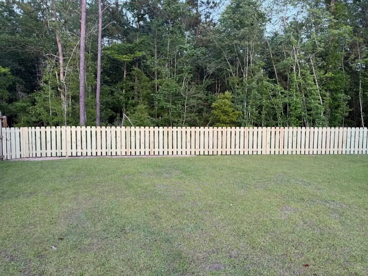 Spaced picket fence in pressure-treated pine installed by Venture Concrete & Fencing