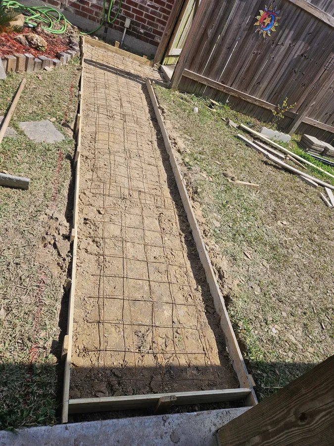 Concrete slab poured near cold frame and garden area